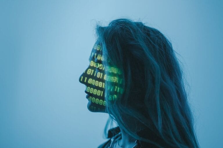 Profile of woman with binary code projected on face glow