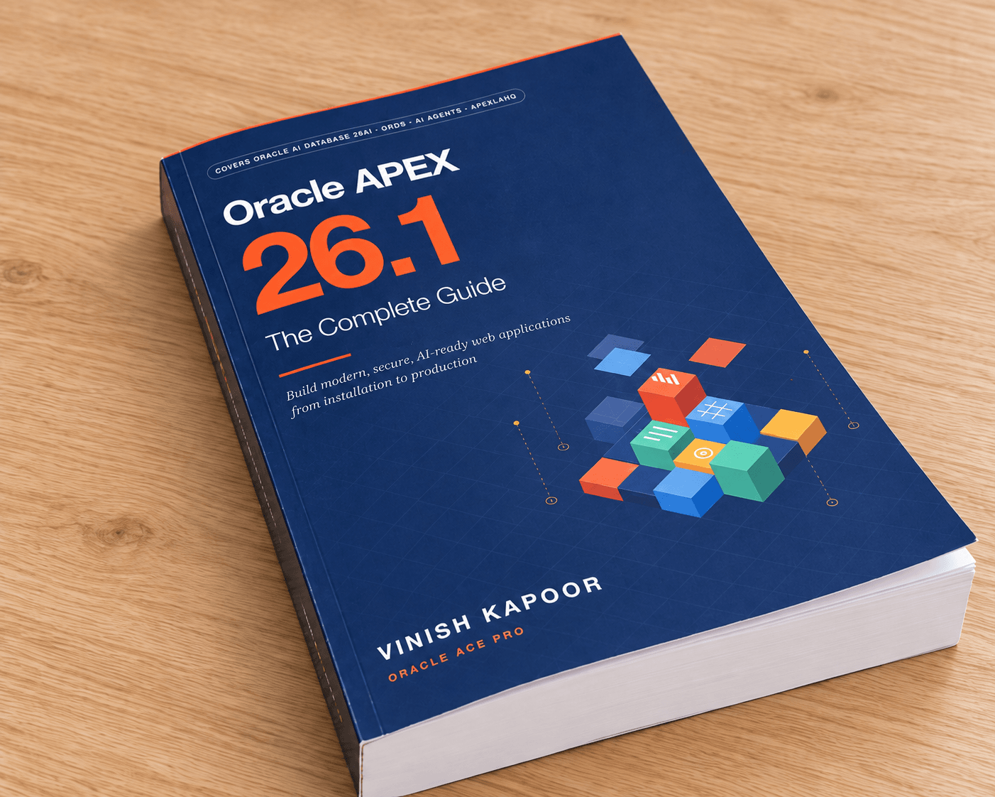 The paperback of Oracle APEX 26.1: The Complete Guide on a wooden table, seen at an angle